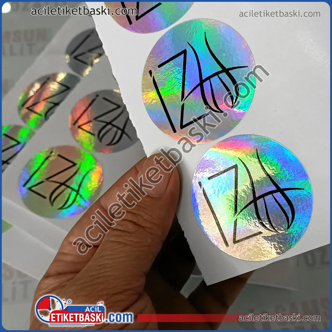 hologram etiket, özel üretim hologram etiket, yuvarlak hologram etiket üzerine baskı, kaliteli hologram etiket baskı, dış mekan dayanıklı ürün, tasarım desteği, acil etiket baskı merkezi, ebat ve adede göre fiyat alınız, aynı gün üretilip gönderilir, harf şeklinde kesim yapılabilir, yurt dışına gönderim yapılır hologram label, custom production hologram label, printing on round hologram labels, quality hologram label printing, outdoor durable product, design support, urgent label printing center, get a price according to size and quantity, can be produced and sent on the same day, can be cut in letter shape, can be sent abroad