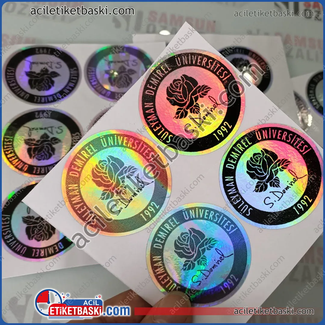 hologram etiket baskı, yuvarlak kesim, etiket, süleyman demirel üniversitesi logo baskılı, etiket, yanar döner hologram etiket baskısı, acil üretim yapılır, tasarım desteği verilir, az adet üretilir, ebat ve adede göre fiyat alınız, dış mekan dayanıklı etiket baskı merkezi hologram label printing, round cut, label, süleyman demirel university logo printed, label, iridescent hologram label printing, urgent production, design support is provided, small quantities are produced, get a price according to size and quantity, outdoor durable label printing center