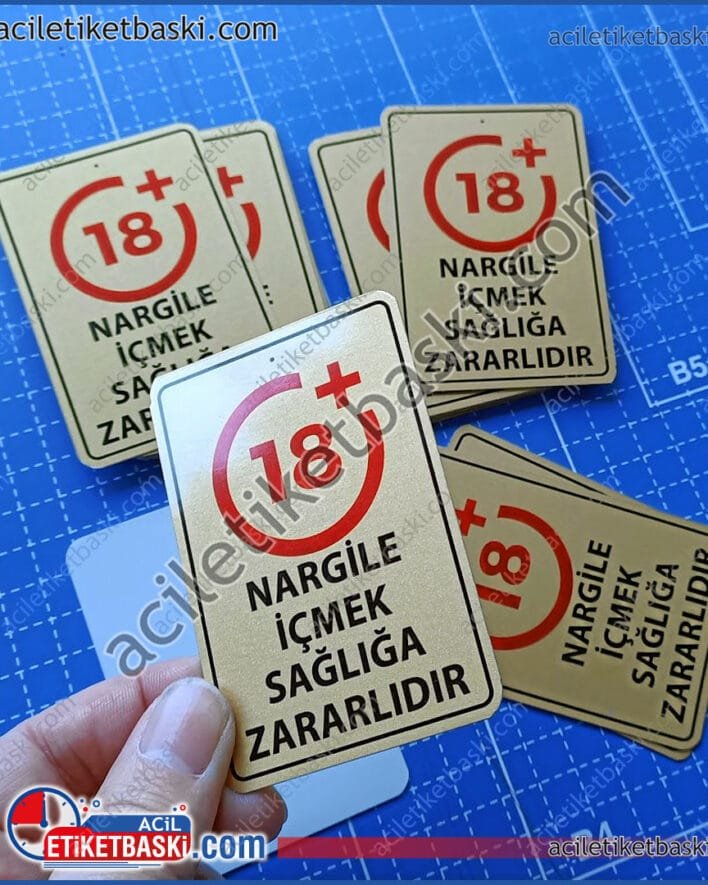 Nargile etiketi, altın renk nargile etiket baskısı, acil etiket baskısı yapılır, yönetmeliğe uygun nargile ve tütün etiket baskısı, metal ürün, üzeri delikli, +18 uyarı etiketi, metal, paslanmaz, alüminyum, altın ve gümüş renk baskıları mümkün, tek yüzey baskılı olarak yapılmıştır, hızlı üretim yapılır, aynı gün gönderilir, acil metal etiket baskı merkezi, metal etiket üretim, imalat ve tasarım, metal etiket fabrikası Hookah label, gold color hookah label printing, urgent label printing is done, regulation-compliant hookah and tobacco label printing, metal product, perforated, +18 warning label, metal, stainless, aluminum, gold and silver color printing is possible, made as single surface printing, fast production, same day dispatch, urgent metal label printing center, metal label production, manufacturing and design, metal label factory